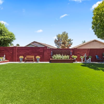 Beautifully landscaped yard with raised planters, turf lawn, and outdoor d cor. A private and inviting outdoor retreat.