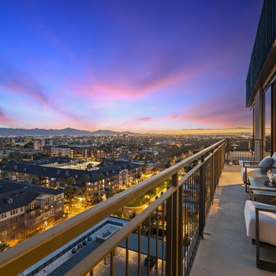Spacious balcony capturing vibrant sunset colors and panoramic Phoenix city views, ideal for evening relaxation and entertaining.