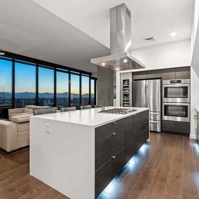 Contemporary kitchen with expansive island and panoramic Phoenix views, enhanced by energy-efficient appliances and modern finishes.
