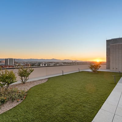 Elevated rooftop capturing colorful sunset skies and cityscape views, perfect for relaxing evenings in Phoenix.