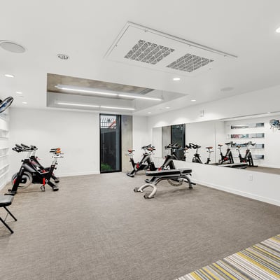 Dedicated studio for yoga and cycling, featuring mirrored walls and flexible space for wellness activities in Phoenix.