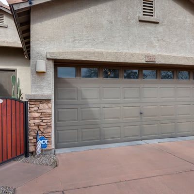 Split garage layout with gated side access and extended slab, perfect for additional parking, tools, or recreational storage in this Phoenix home.