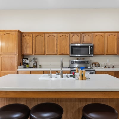 Bright kitchen and dining area with natural light, ample cabinetry, and open flow to living spaces in this Phoenix home.