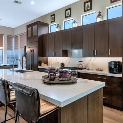 Elegant kitchen featuring a large island, quartz countertops, and high-end appliances, offering both beauty and performance in this Phoenix home.