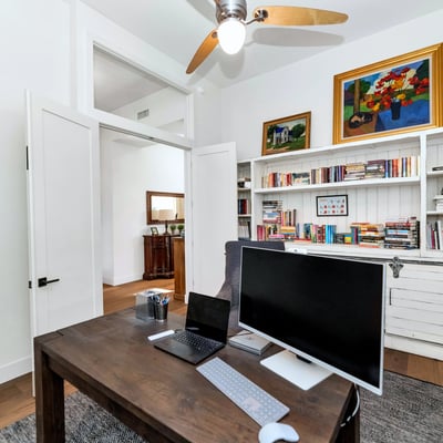 Home office with built-in bookshelves and storage, providing both style and practicality in this Phoenix residence.