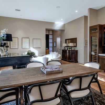 Stylish dining area with custom cabinetry, wine storage, and wood finishes, offering both function and elegance in this Phoenix home.