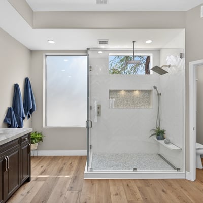Upgraded Scottsdale bathroom showcasing a glass-enclosed shower, custom tile accents, and modern fixtures.
