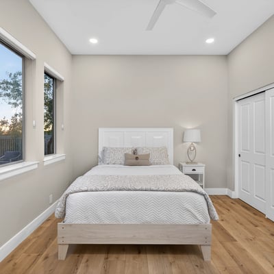 Spacious Scottsdale bedroom featuring ample closet storage, wood flooring, and natural light for everyday comfort.