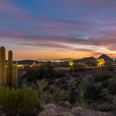 Scottsdale desert scenery with saguaro cacti, rolling hills, and colorful sunset skies, offering a peaceful and picturesque setting.