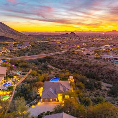 Scottsdale aerial highlighting nearby mountains, desert landscape, and surrounding homes in a scenic environment.