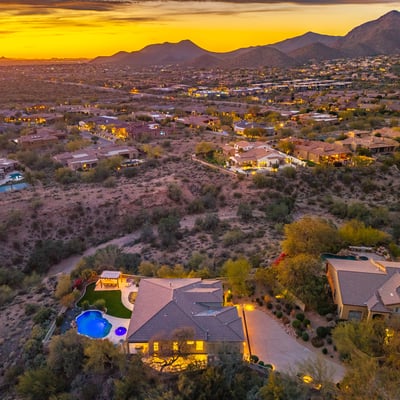 Scottsdale aerial capturing expansive desert views, surrounding homes, and vibrant sunset colors.