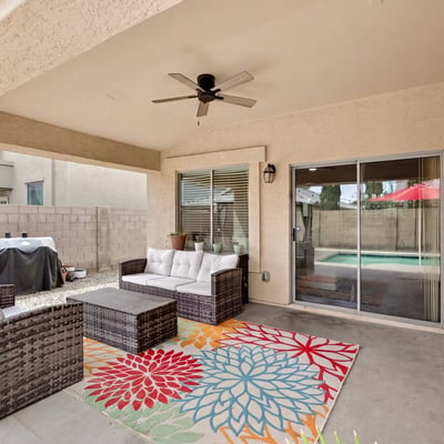 Outdoor living space with covered patio and seating area, perfect for relaxing or hosting. Easy access to the pool enhances the Casa Grande lifestyle.