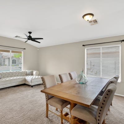 Dining area with large windows and inviting atmosphere. Ideal for gatherings and everyday meals in this Casa Grande home.