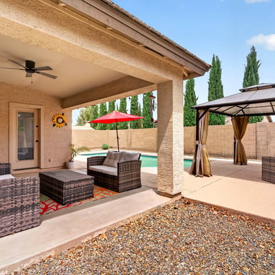 Covered patio with seating and views of the pool and pergola area. Designed for entertaining and enjoying Arizona-style outdoor living in Casa Grande.