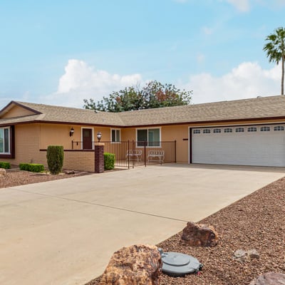 Clean exterior with attached two-car garage and extended driveway. This updated Sun City home provides convenience, storage, and modern upgrades.