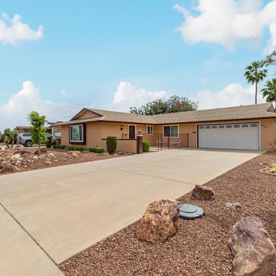 Side angle highlighting the home s structure, landscaping, and spacious lot. Located in Sun City, this property offers low-maintenance outdoor living.