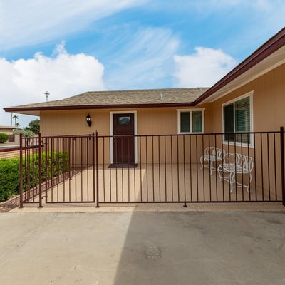 Secure front patio with gated entry, ideal for outdoor seating. This Sun City home features updated finishes and inviting outdoor spaces.