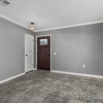 Entryway with sleek tile flooring, fresh paint, and updated lighting. This Sun City home offers a clean, contemporary interior feel.