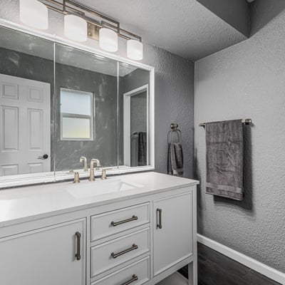 Updated bathroom vanity with sleek countertop, modern fixtures, and bright lighting. This Sun City home offers refreshed spaces with stylish upgrades.