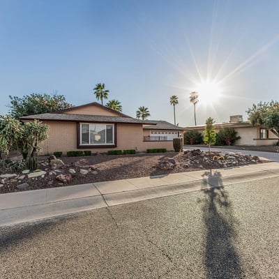 Beautiful front yard with desert landscaping, mature greenery, and attractive curb appeal. This Sun City home offers easy-care outdoor spaces and a welcoming exterior.