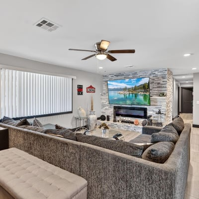 Updated living space with sleek fireplace, neutral palette, and modern finishes, offering comfort and style in this Phoenix home.