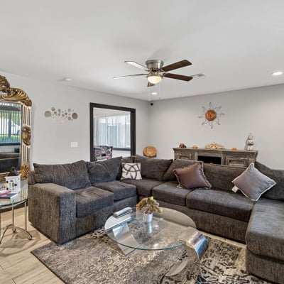 Inviting living room with updated flooring and abundant natural light, enhancing the overall appeal of this Phoenix remodeled home.