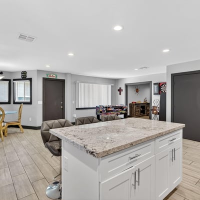 Kitchen island with bar seating connects seamlessly to living and dining areas, ideal for entertaining in this Phoenix home.