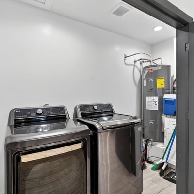 Convenient interior laundry space with appliances and storage, enhancing everyday functionality.