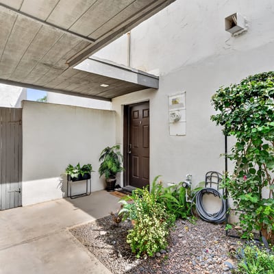 Private Scottsdale covered entry with desert landscaping and shaded design, creating a welcoming and low-maintenance entrance to the home.