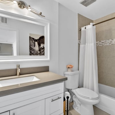 Scottsdale bathroom with modern vanity, framed mirror, and tiled tub-shower combo, delivering style and everyday convenience.