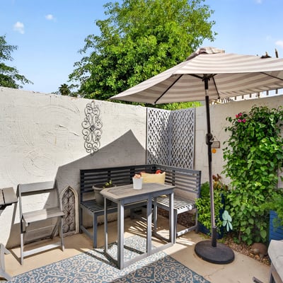 Comfortable Scottsdale patio with seating, shade, and garden accents, creating a warm and welcoming outdoor space.
