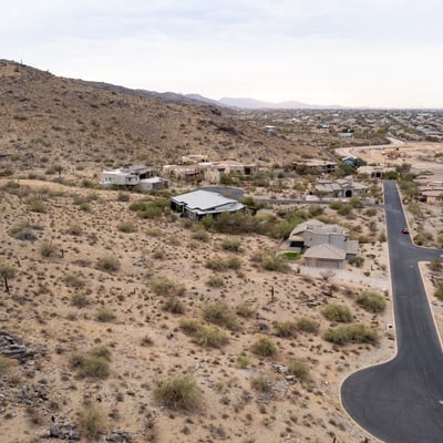 Wide panoramic aerial view capturing stunning desert landscapes, valley scenery, and hillside surroundings. This luxury Phoenix homesite offers privacy, views, and custom home potential in a scenic setting.