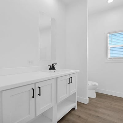 Well-appointed hall bathroom with contemporary finishes, stylish cabinetry, updated fixtures, and durable flooring. The bright design and functional layout make it ideal for family members and guests alike.