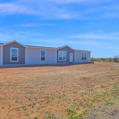 Exterior perspective highlighting the home's expansive acreage and scenic desert surroundings. The large lot provides privacy, flexibility, and room to create the lifestyle you've always wanted.