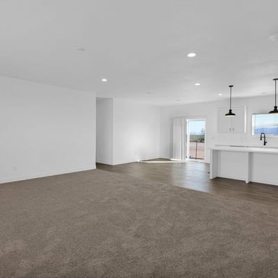 Large open living area flowing effortlessly into the stylish kitchen. Featuring modern finishes, energy-efficient construction, and an oversized island, this design is perfect for both entertaining and daily comfort.