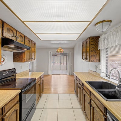 Offering abundant cabinetry and practical workspace, this kitchen provides functionality and convenience. Easy access to adjacent living spaces makes it ideal for everyday meals and gatherings.