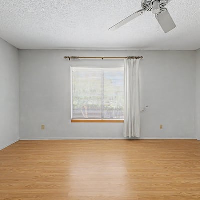 Featuring abundant natural light and attractive flooring, this spacious owner's suite provides a peaceful retreat within the home. The flexible layout allows room for additional seating, workspace, or personalized furnishings.