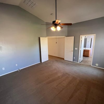 Well-designed primary suite with vaulted ceilings, neutral d cor, and convenient access to the ensuite bath. The open feel creates a relaxing environment ideal for everyday living.