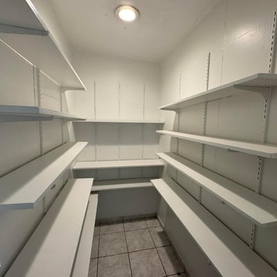 Oversized walk-in pantry with wall-to-wall shelving and dedicated storage areas for kitchen essentials. This desirable feature adds convenience, organization, and valuable storage capacity for everyday living.