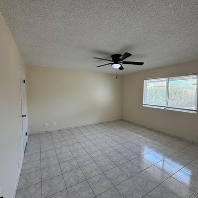 Well-appointed bedroom with generous dimensions, tile flooring, and natural light. Perfect for guests, family members, or creating a productive work-from-home environment.