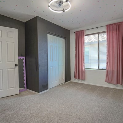 Bright secondary bedroom with soft carpeting, a large window, and convenient closet storage. This versatile room is perfect for a nursery, guest bedroom, playroom, or home office.