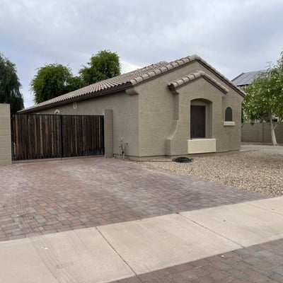 Beautiful front fa ade with a covered entry, attached garage, and mature landscaping welcomes you home with timeless curb appeal and easy-maintenance desert landscaping.