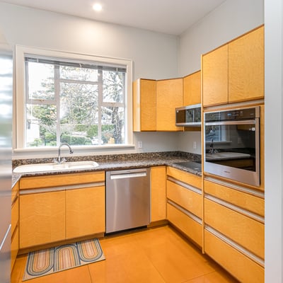 Bright and modern kitchen featuring ample storage, sleek appliances, and a view of the landscaped garden.