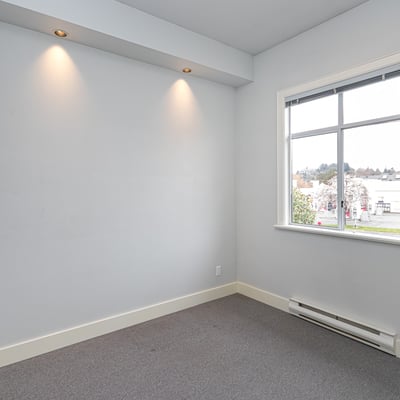 Bright, versatile room with natural light, perfect for a home office or creative space.