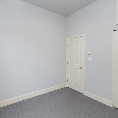 Bright and spacious room with neutral tones, offering ample storage and potential for customization.
