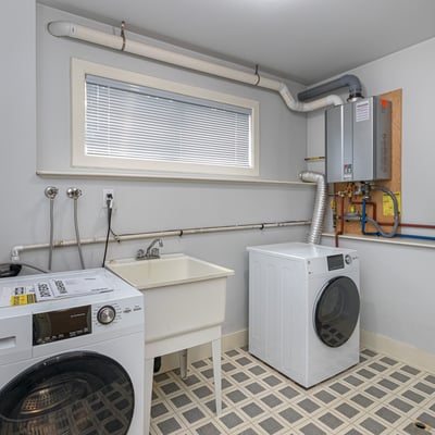Bright laundry room featuring modern appliances, ample storage, and convenient hookups for all your laundry needs.