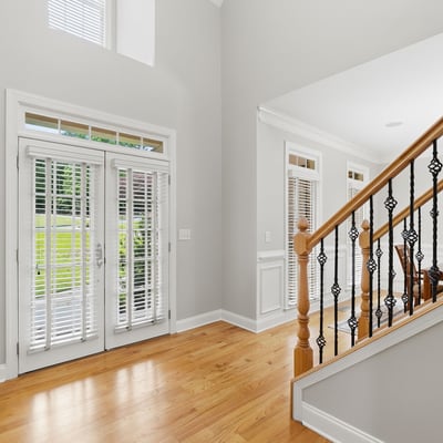 Welcoming foyer features modern design and abundant natural light, leading to an open dining area.