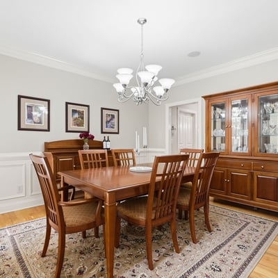 Elegant formal dining room with hardwood floors, detailed wainscoting, crown molding, and room to gather comfortably for holidays, dinner parties, and everyday celebrations.