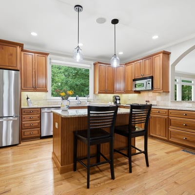 Spacious kitchen featuring custom cabinetry, modern fixtures, and an inviting island perfect for hosting gatherings.