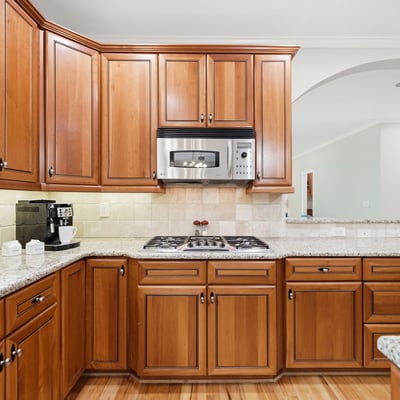 Experience this inviting kitchen, featuring rich wood cabinetry, granite counters, and modern stainless steel appliances.